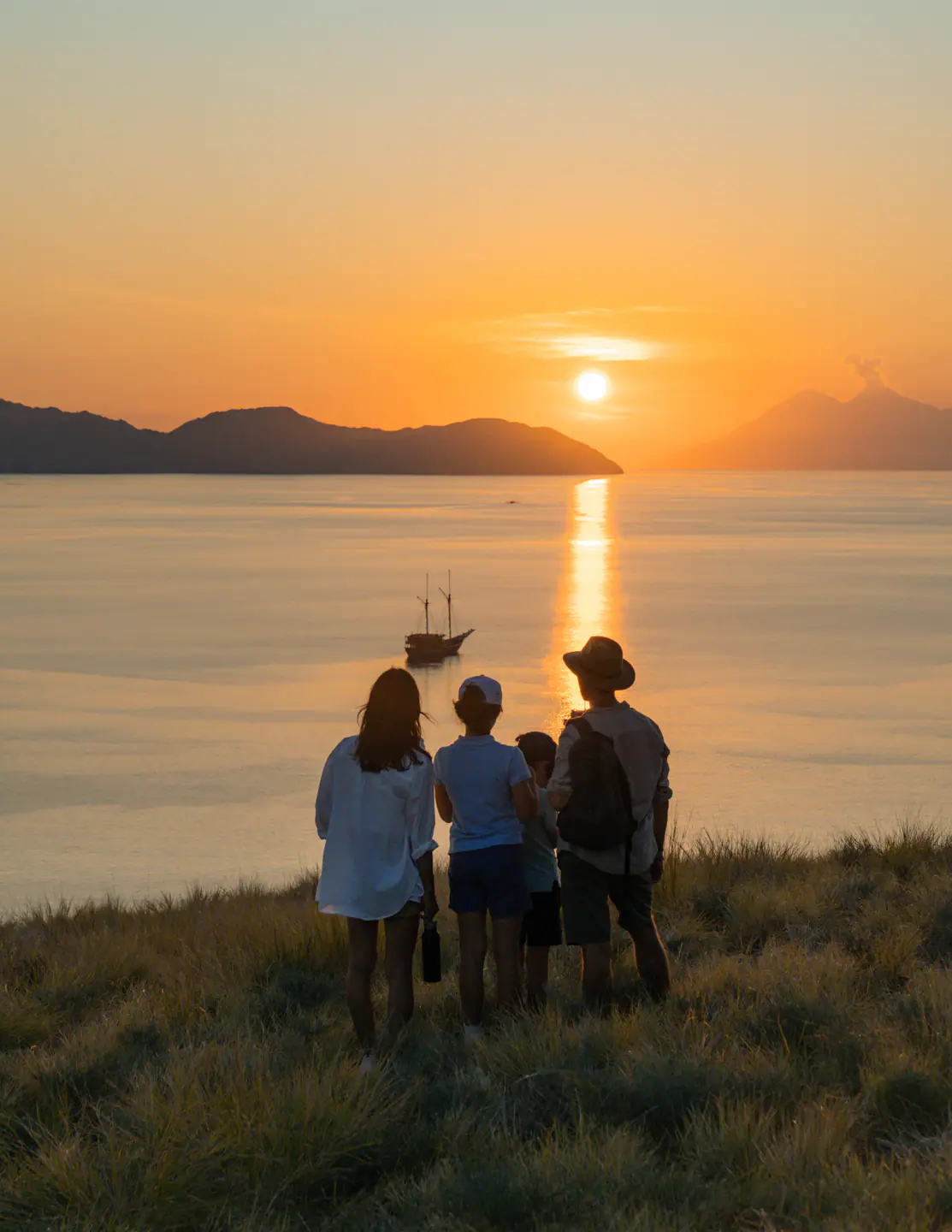 Guests watching the sunset from a phinisi deck